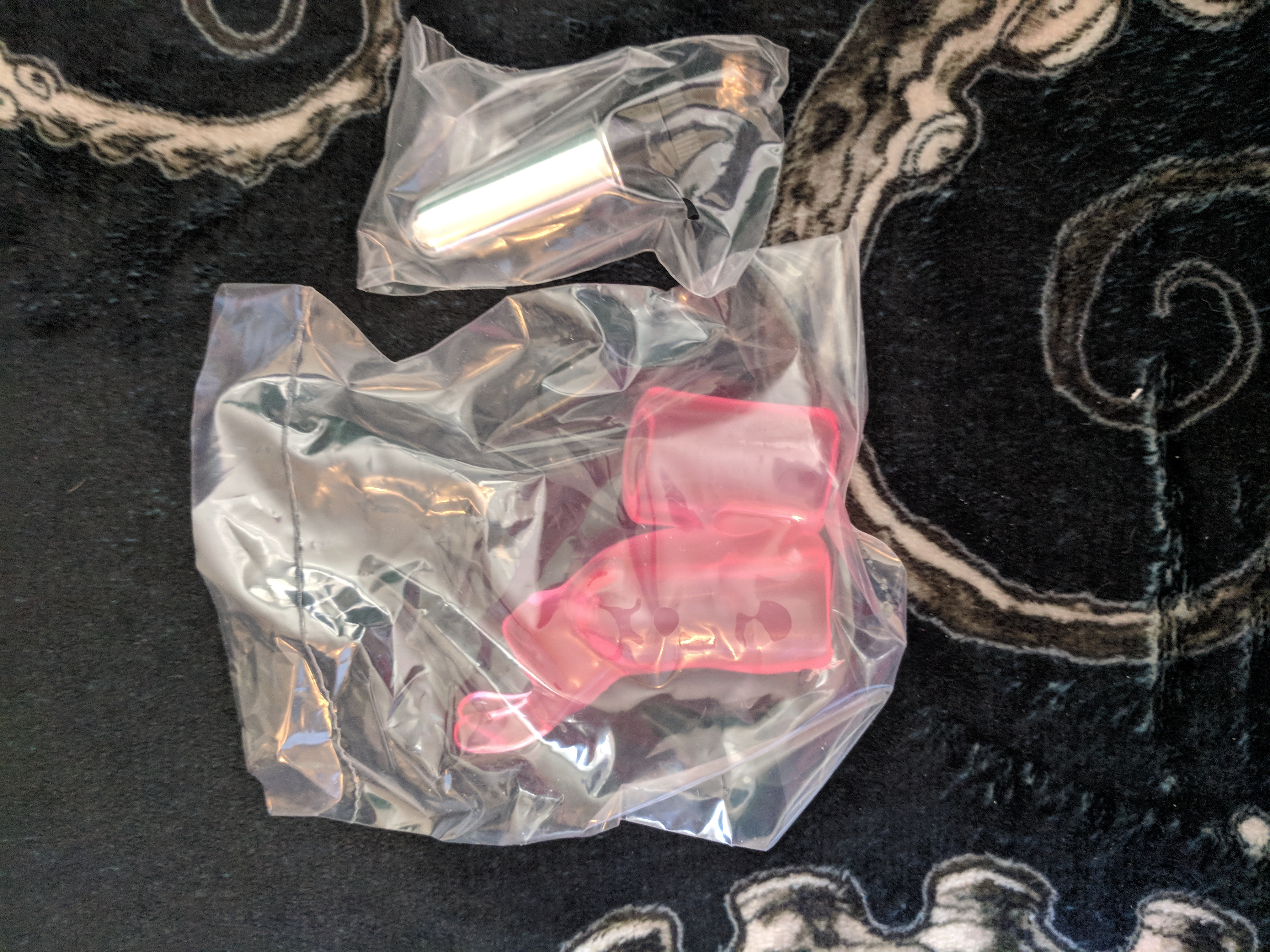 Pocket bunny vibrator box opened, with each toy part wrapped in separate plastic bags
