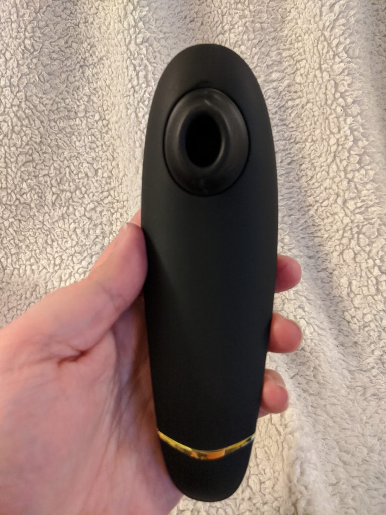 Premium in hand, nozzle facing camera