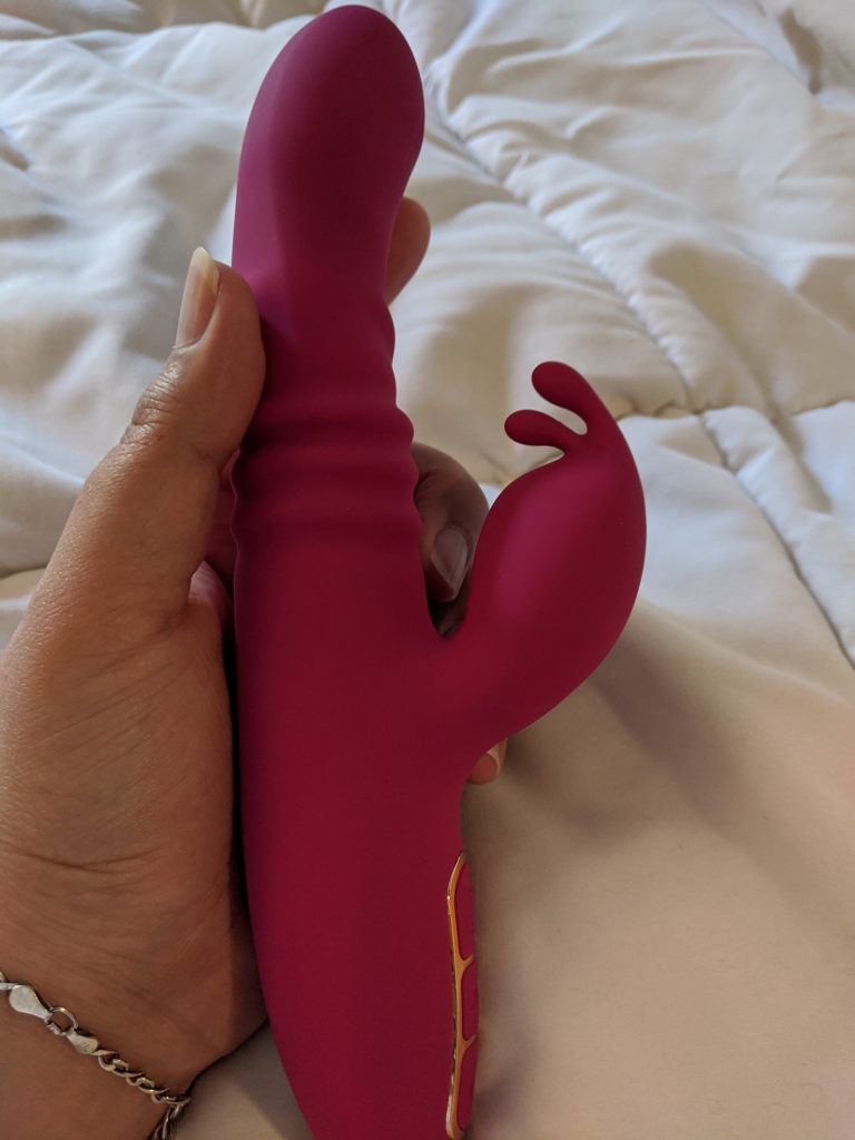 Blush lush kira from side with accordion style base and clit stimulator visible