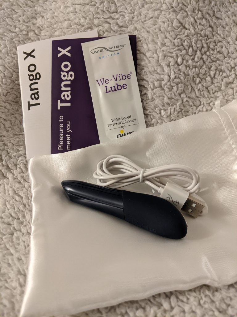 Tango x with charger, storage bag, lube, and instructions
