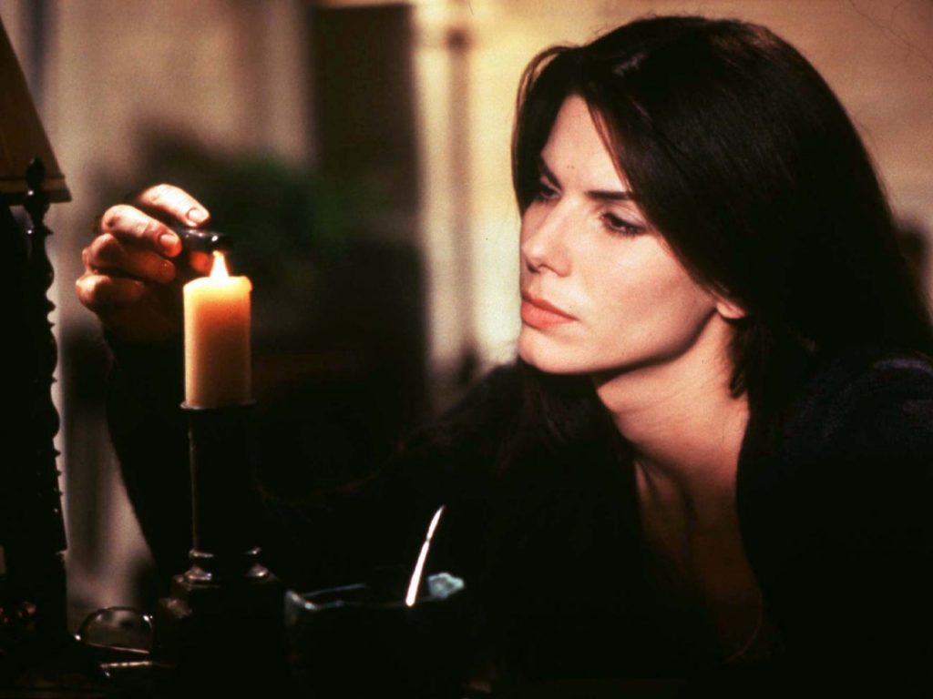 Sandra Bullock lighting a candle in Practical Magic