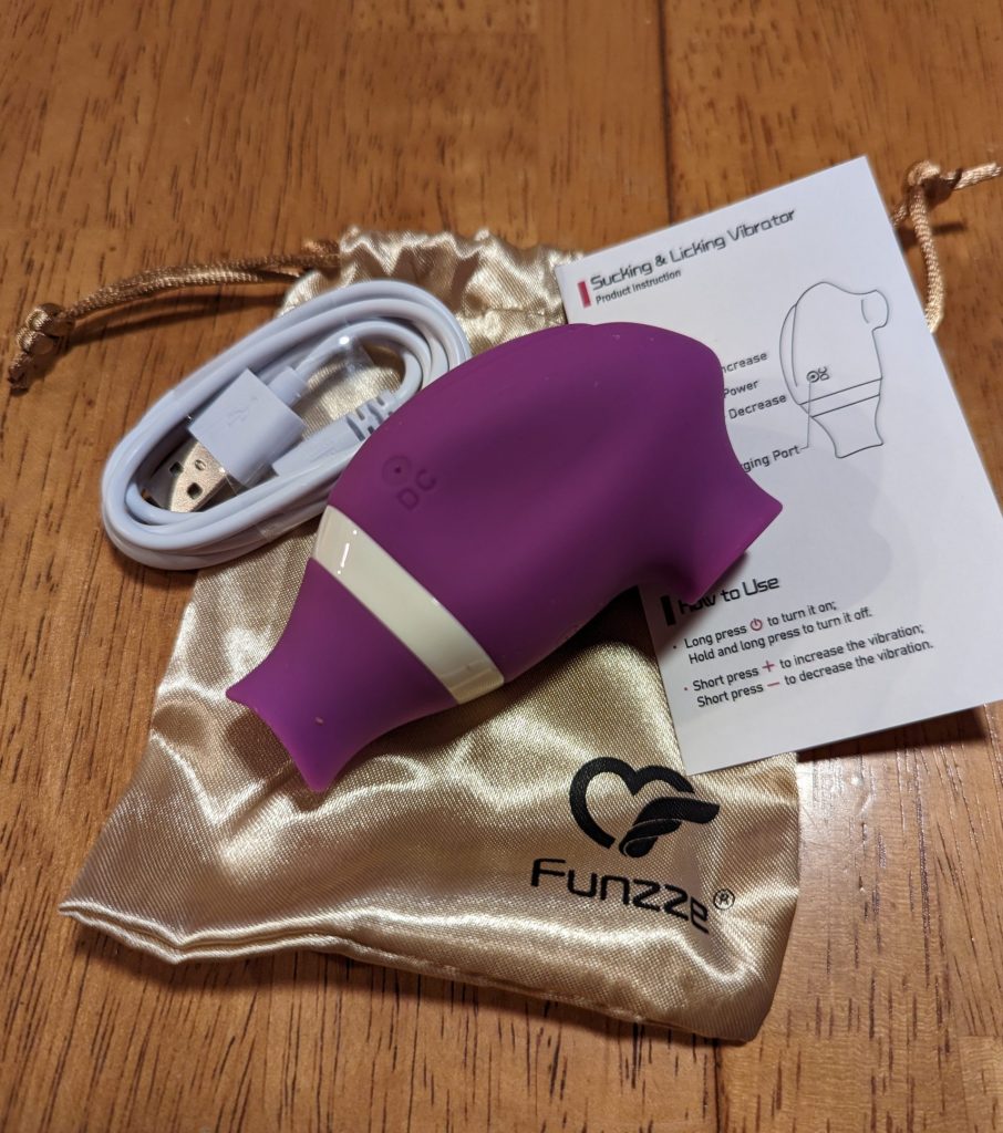 Funzee Licking & Sucking vibrator with charging cable and instructions, plus bag