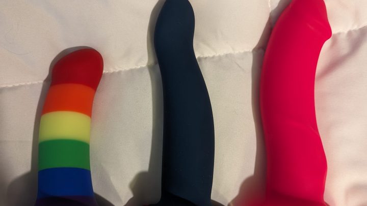 Three dildos side by side on a white background