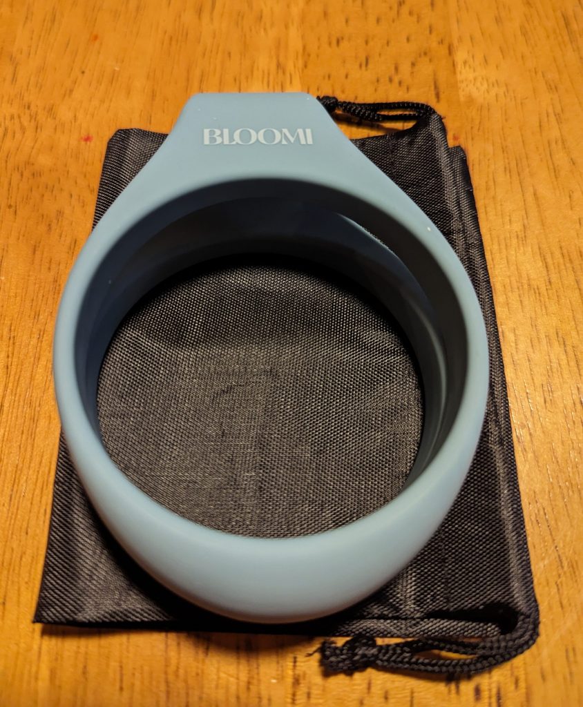 Link flexible handcuffs folded in half, resting on the storage bag